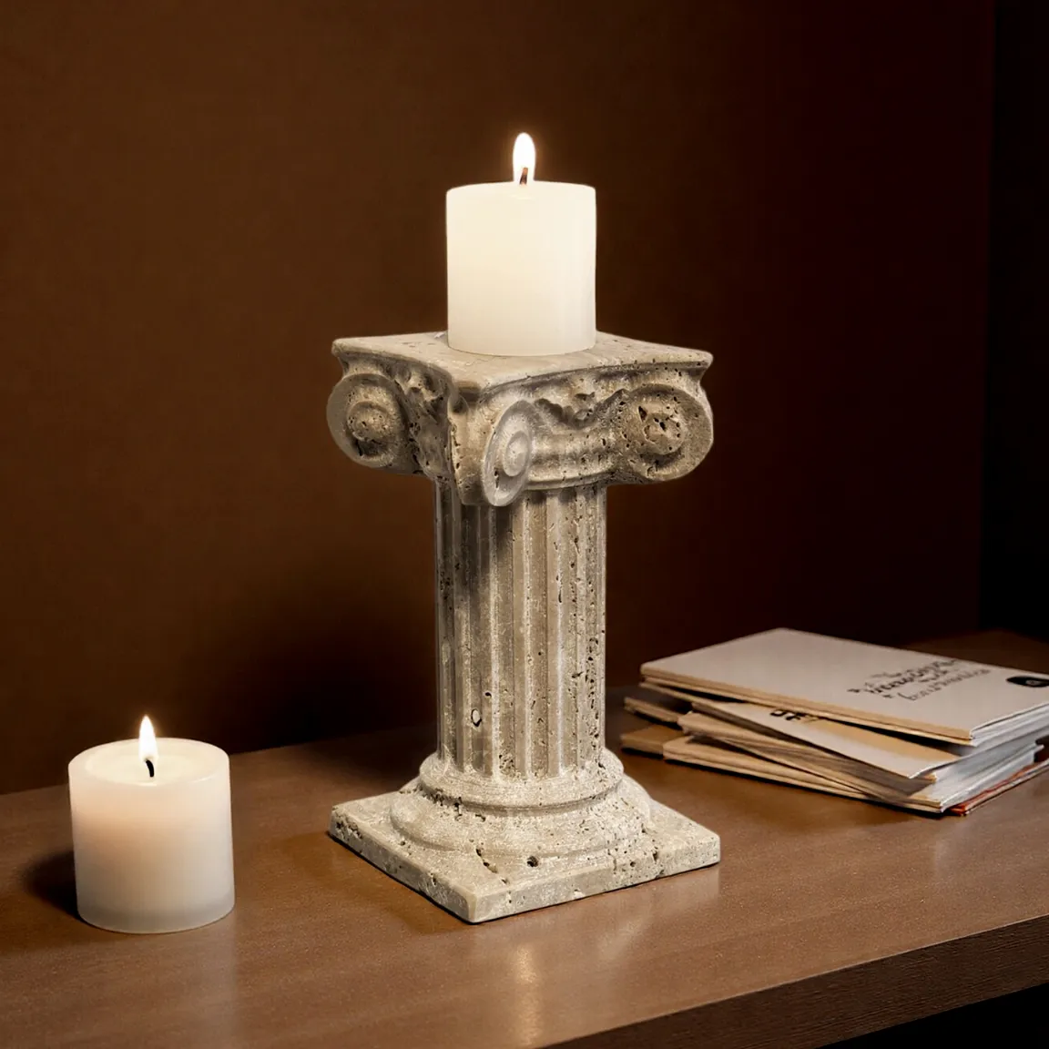 Travertine marble Roman column candle holder with lit white candle, styled on a wooden table for home decor